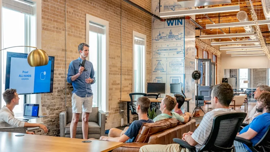 Presenter speaking to a team gathered in an office